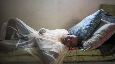 Abo Bakr Mohammed, 12, who suffers from epilepsy, covers himself with a mosquito net in his family's room, at an orphanage that has been turned into a center for Yemeni refugees.