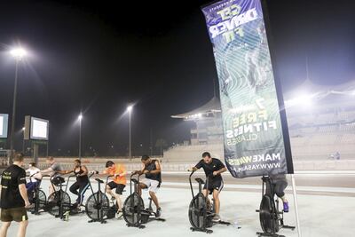 Participants try their hand at the assault bike station at the Get Driver Fit launch. Photo Courtesy: Hill+Knowlton Strategies