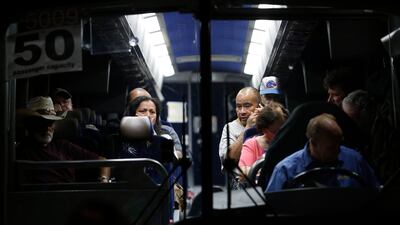 Festival attendees are whisked away from the scene on buses. AP