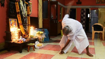 Indian monk Swami Sivananda practises yoga in Kolkata.