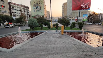 Fatemi Square with its fountains coloured red.