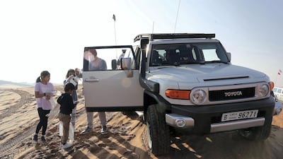 Members of the Offroaders.ae desert driving club collect rubbish during a clean up drive at the Al Badayer desert area in Sharjah. All photos by Pawan Singh / The National