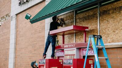 Workers board up a Walgreens store ahead in preparation for the arrival of Hurricane Delta in Morgan City, Louisiana. Bloomberg