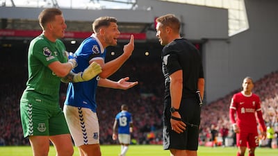 Everton's goalkeeper Jordan Pickford, left, Everton's James Tarkowski, centre, argue with referee Craig Pawson. AP