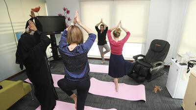 Legally binding contracts between schools and parents were brought in to 58 schools in 2013 as a pilot programme by the Knowledge and Human Development Authority, whose employees can be seen taking a yoga break at the KHDA headquarters in Dubai Academic City. Sarah Dea / The National