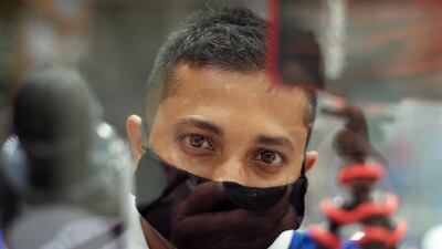 A vendor wears a protective face mask following the coronavirus outbreak, as he looks on at his shop in local souq, in Manama, Bahrain. Reuters