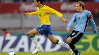 Kaka, left, fights for the ball with Diego Forlan during a World Cup 2010 qualifying soccer match against Uruguay on Saturday.
