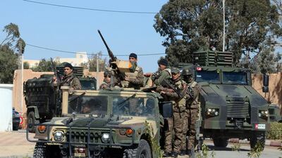 Tunisian soldiers patrol a street in Ben Guerdanem on March 13, a week after jihadists launched a wave of attacks on army and police posts in the border town. Fathi Nasri / AFP