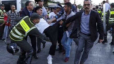 Members of the security forces detain a protester. AFP