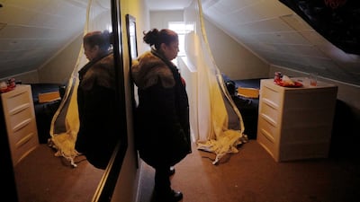 Maritza, who spent time in the hospital with the coronavirus disease COVID-19 and when she was released was locked out of her apartment by fearful roommates, stands in the new room she is renting in an apartment in Chelsea, Massachusetts, U.S. After Maritza lost all her belongings along with her housing, La Colaborativa provided temporary housing, helped her replace her clothes and furniture, and helped her move in to a new rental room in an apartment. REUTERS