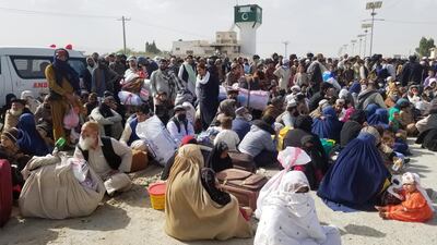 People gather as they are waiting to cross as Pakistan opens its border with Afghanistan that was closed in preventive measure following an outbreak of coronavirus. Reuters