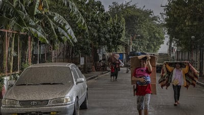 Residents walk along a road covered in ash mixed with rainwater as Taal Volcano erupts in Talisay, Batangas province, Philippines. Getty Images