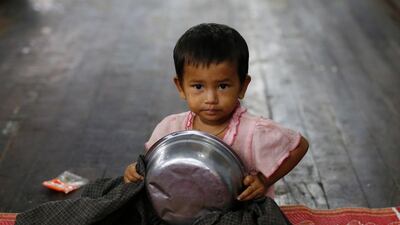 A child sits on the ground at a temporary evacuation center in Hpa-An Township, Kayin State, Myanmar. EPA / LYNN BO BO
