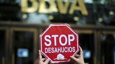 A man protests in front of a BBVA bank office in Barcelona. AP Photo