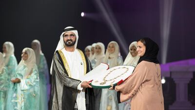 ABU DHABI, UNITED ARAB EMIRATES - March 21, 2016: HH Sheikh Mohamed bin Rashid Al Maktoum, Vice-President, Prime Minister of the UAE and Ruler of Dubai (center L) presents the Zayed Medal to HH Sheikha Lubna Al Qasimi, UAE Minister of State for Tolerance, (center R) who is receiving it on behalf of HH Sheikha Fatima bint Mubarak Al Nahyan (not shown), during the Mother of the Nation Festival opening ceremony at Abu Dhabi National Exhibition Centre (ADNEC). ( Ryan Carter / Crown Prince Court - Abu Dhabi ) *** Local Caption *** 20160321RC_C067893.jpg