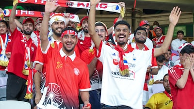 Sharjah FC fans cheer during the President’s Cup finals match at the Hazza bin Zayed Stadium in Al Ain. Victor Besa / The National