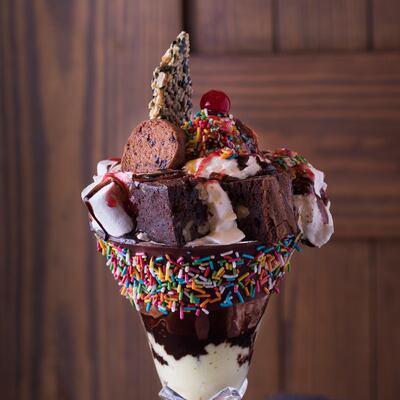 The Brownie Decadence is served in a tall glass, is stacked layers of warm chocolate brownies covered in ice cream, fudge, marshmallows and sprinkles. Courtesy Publique