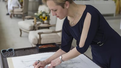 Artist Vinet Sayer sketches horses at the Desert Palm Per Aquum Resort in Dubai. Antonie Robertson / The National