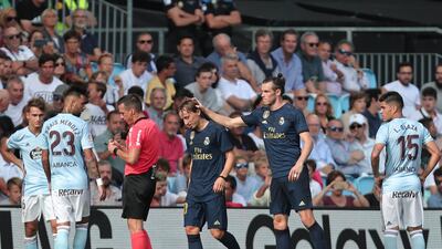 Luka Modric, centre left is consoled by Gareth Bale after receiving a red card. AP Photo