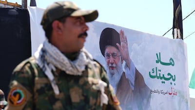 A poster of Iran's former supreme leader Ayatollah Ali Khamenei looms over an area of Karbala, Iraq, guarded by the Popular Mobilisation Forces. AFP