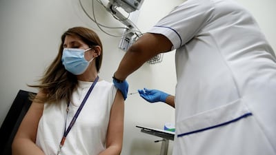 A woman receives a dose of the Pfizer-BioNTech vaccine at Zabeel Health Centre in Dubai. EPA