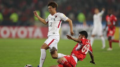 Persepolis player Ali Moslem Taklimi tackles Koki Anzai of the Kashima Antlers. Getty Images