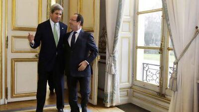John Kerry, the US secretary of state, walks with French President Francois Hollande after their meeting in Paris on Wednesday. Jacquelyn Martin / Reuters