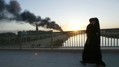 A fire at a looted warehouse burns near the Tigris river in Baghdad. AP