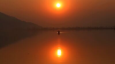 A boatman rows on Dal Lake in Srinagar, the summer capital of Indian Kashmir, as the sun sets. EPA