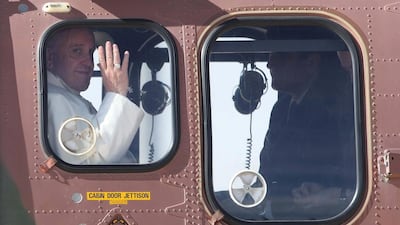 Pope Francis, left, waving from a Jordanian military helicopter as he leaves Jordan on his way to Bethlehem, the West Bank. Jamal Nasrallah/ EPA
