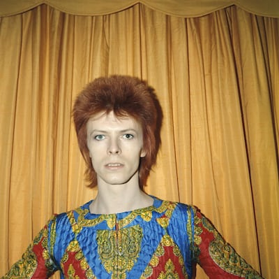David Bowie poses for a portrait dressed as Ziggy Stardust in a hotel room in 1973. Getty Images