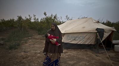Mona Hussein, 33, holds her daughter Zahra, 30 days old.
