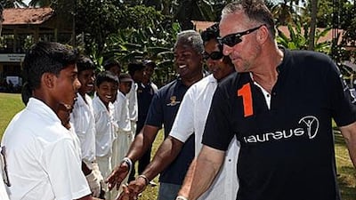 Young Seenigama cricketers meet Sir Ian Botham, followed by the former Sri Lanka bowler Chaminda Vaas and Kushil Gunasekera.