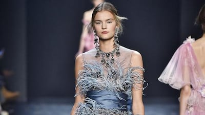 Baby-blue ostrich feathers extend from this beaded, tea-length dress in an elegant take on 1920s flapper style. Courtesy Marchesa