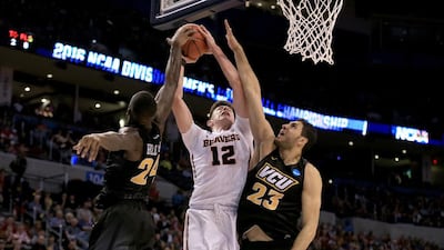OKLAHOMA CITY, OKLAHOMA - MARCH 18: Drew Eubanks #12 of the Oregon State Beavers goes up for a shot between Korey Billbury #24 and Ahmed Hamdy-Mohamed #23 of the Virginia Commonwealth Rams in the second half in the first round of the 2016 NCAA Men's Basketball Tournament at Chesapeake Energy Arena on March 18, 2016 in Oklahoma City, Oklahoma. Tom Pennington/Getty Images/AFP== FOR NEWSPAPERS, INTERNET, TELCOS & TELEVISION USE ONLY ==