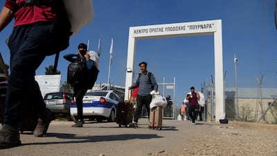 Migrants leaving a reception centre on the outskirts of Nicosia, Cyprus. AP