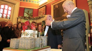 Britain's King Charles cuts a cake in the shape of the Cyfarthfa Castle in Wales, during an event to celebrate the monarch's 77th birthday and the castle's 200th anniversary, in Merthyr Tydfil. AP