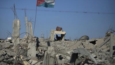 A Palestinian flag waves in Khuzaa in the southern Gaza Strip. British MPs will on Monday vote on whether to recognise Palestine as a state. Khalil Hamra / AP Photo