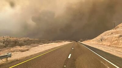 Smoke from the Windy Deuce wildfire billows across a road in the panhandle region of Texas. EPA