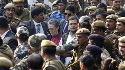 India's Congress party vice president Rahul Gandhi (C-R-White Shirt) walks along with his mother and Congress party president Sonia Gandhi (C-L-Red Saree) as they arrive at Patiala House Court in New Delhi, India, on December 19, 2015. Rajat Gupta/EPA