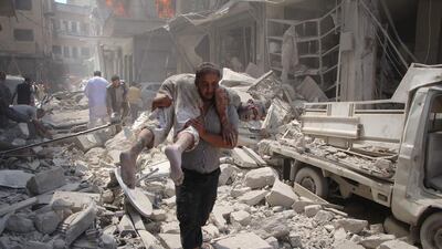 A man carries a victim following an air strike on the rebel-held Syrian city of Idlib on September 10, 2016. The Syrian government is expected to ground its air force under a ceasefire scheduled to take effect from September 12, 2016. Omar Haj Kadour / AFP