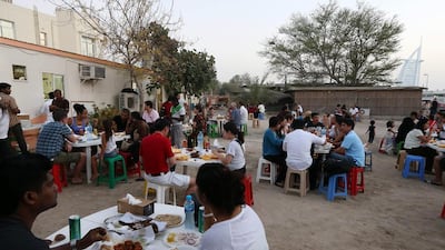 People sit to eat at Bu Qtair Restaurant in the shadow of the Burj Al Arab.