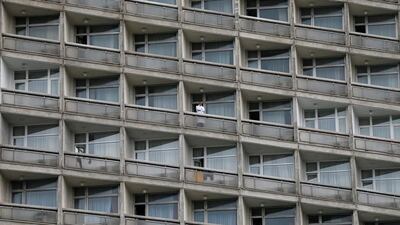 A man stands on the balcony of a hotel as he watches a rally organised by members of Ukrainian trade unions in Kiev. Gleb Garanich / Reuters
