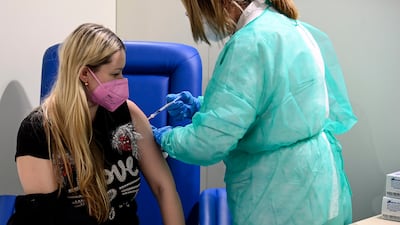 A woman receives a Covid-19 vaccine in Rome. Newly approved shots will form part of a booster campaign set to be introduced across the 27 EU nations. EPA