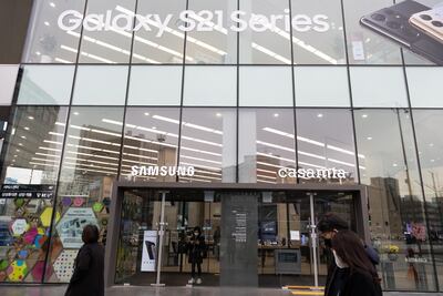 Pedestrians walk past a Samsung store in Seoul. Bloomberg