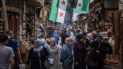 People shop at a market in Damascus. Syria is relatively thriving under President Ahmad Al Shara, while Lebanon remains mired in problems. Getty Images