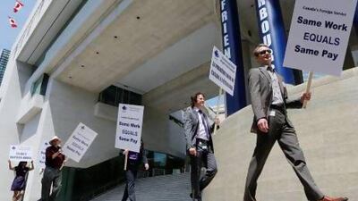 Canadian foreign service officers involved in a labour dispute with Canada's Treasury Board protest at the Canadian Embassy in Washington earlier this year. The dispute has spread around the globe to affect Canadian embassies in 15 countries. Jason Reed / Reuters