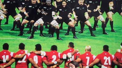 A commuter walks past a poster advertising the Japan 2019 Rugby World Cup in the Tokyo district of Aoyama. AFP