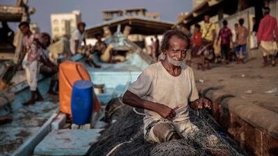 In this Sept. 29, 2018, photo, 71-year-old Yemeni fisherman Ammar Ahmed prepares his nets before a fishing trip at the main fishing port, in Hodeida, Yemen. (AP Photo/Hani Mohammed)