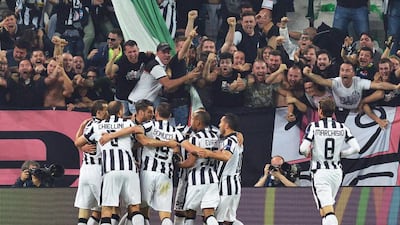 Juventus players mob Alvaro Morata after his opening goal on Tuesday night in the Champions League semi-final first leg against Real Madrid in Turin. Andrea Di Marco / ANSA / AP